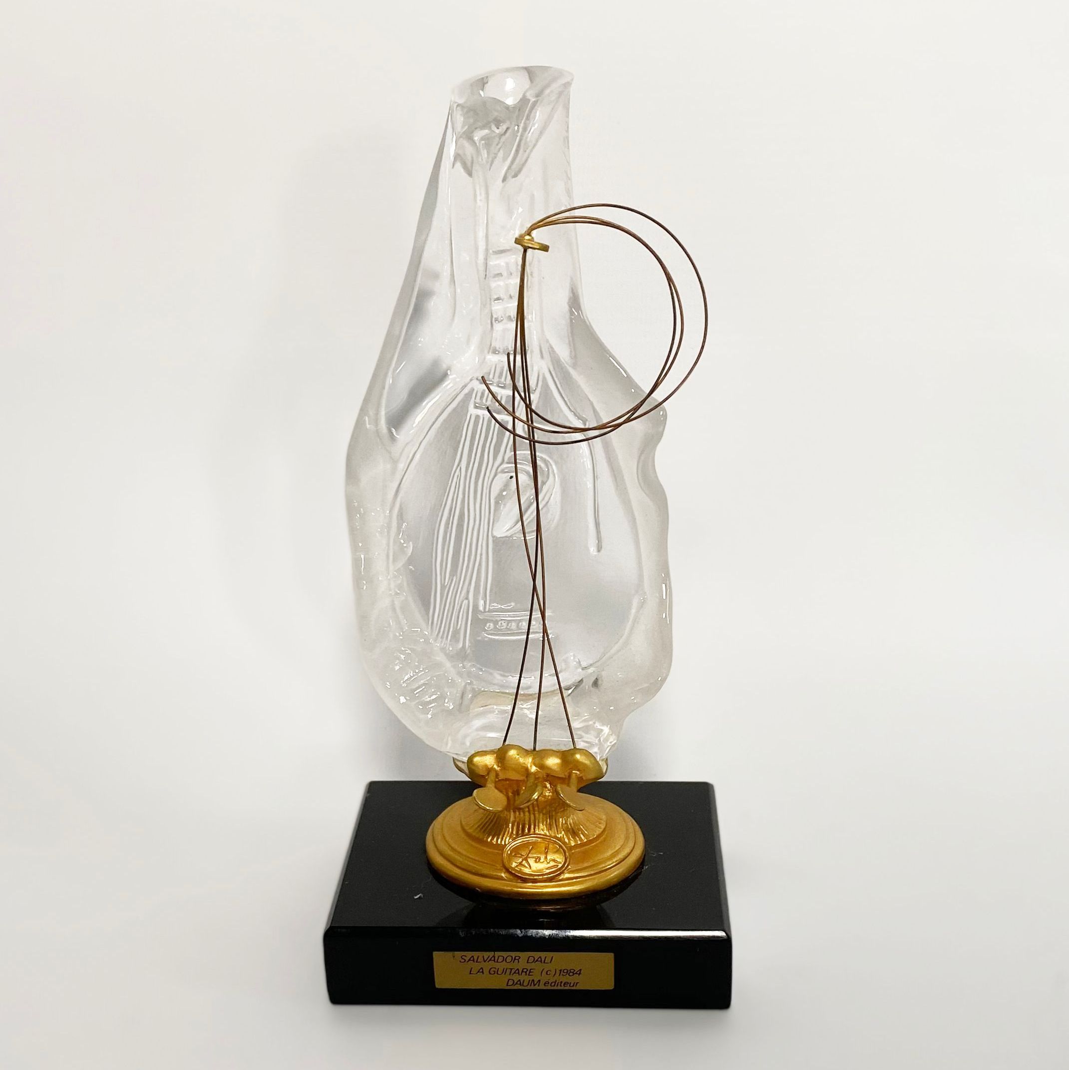 Dali, sculpture in gilded bronze and glass