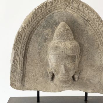 KHMER art, Cambodia, 12th/13th century. Part of a grey sandstone stele featuring the head of a deity (Uma?)