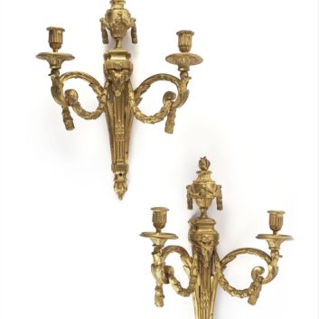 Pair of two-light sconces in chased and gilded bronze