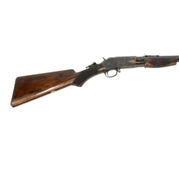 Colt 1887 rifle. Pump system and tubular magazine under the barrel.